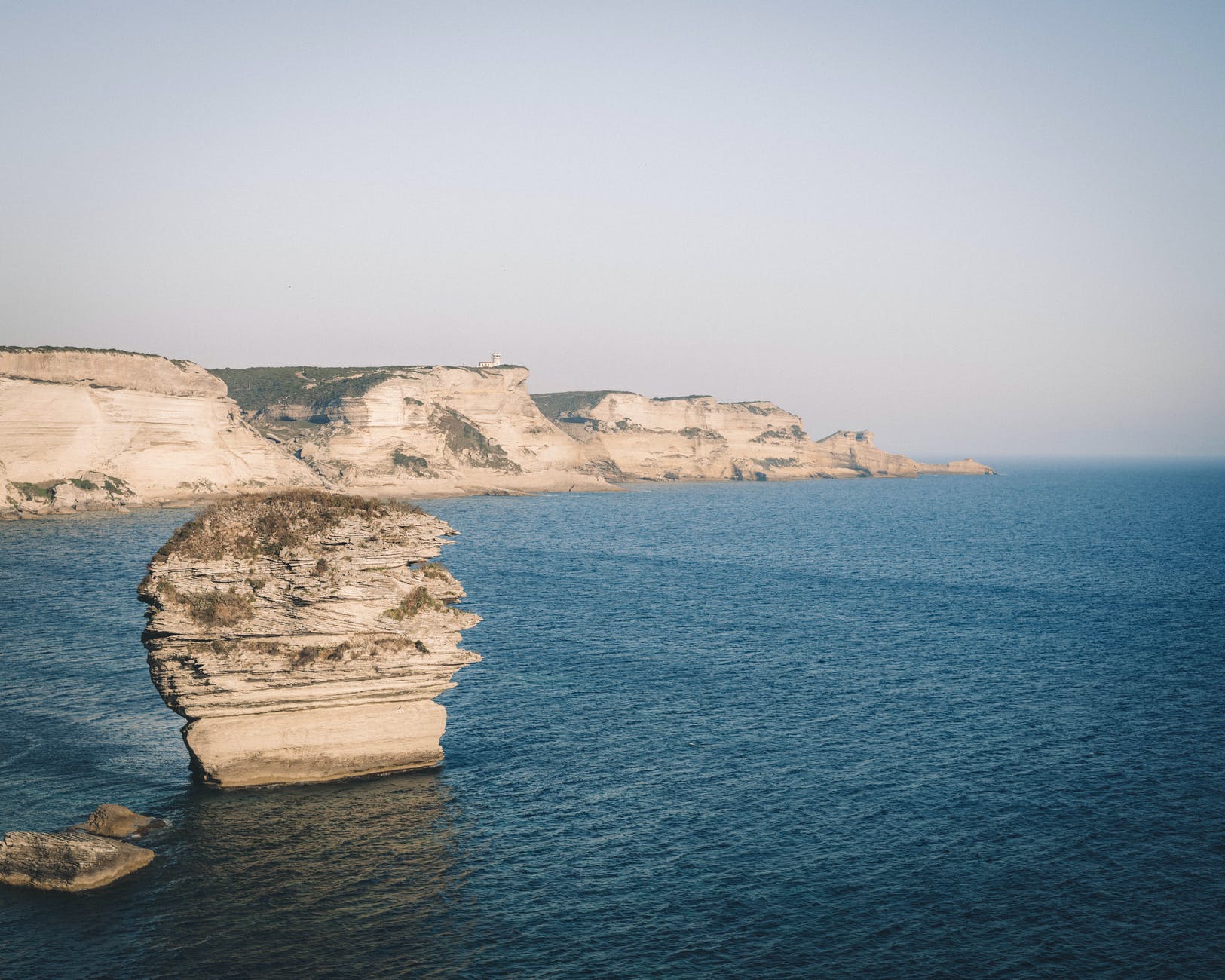 gray rock formation on body of water